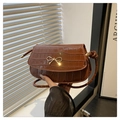 Brown faux crocodile leather handbag with a golden metal bow and crossbody strap - Brown