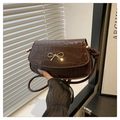 Dark brown faux crocodile leather shoulder bag featuring a gold bow accent and knot strap - Brown