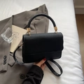 Elegant black woven leather crossbody bag with golden metal hardware and round handle - Black