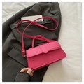 Fuchsia minimalist small square handbag with golden hardware on a grey suit jacket - Rose Pink