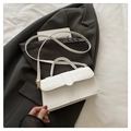 Elegant white faux leather handbag with top handle and golden buckle on gray fabric - White