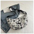 Detailed top view of a crescent canvas crossbody bag with monochrome nature print - Black