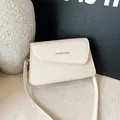 Chic beige crossbody bag with herringbone weave texture and gold fashion lettering - White