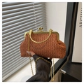 Detail of woven straw handbag featuring vintage gold clasp and elegant ring handle - Brown
