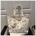 Detail of off-white corduroy tote bag with cherry pattern and matching small coin purse - White