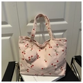 Detail of pink corduroy tote bag with red cherry prints and matching round coin purse - Pink