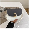 Close-up of contrast color saddle bag with golden U-shaped lock on white background - White