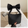 Black matte handbag featuring a large bow handle and silver chain shoulder strap - Black