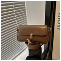 Detail of vintage brown leather underarm bag featuring a golden rectangular lock closure - Brown