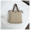 Top view of beige tote bag with striped shoulder strap and metallic flower logo detail - Off White