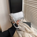 Silver lychee grain leather handbag with knot handle shown held by model in indoor setting - Silver