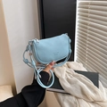 Light blue lychee texture crescent bag with knotted strap and metal charm detail - Blue
