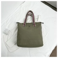 Detail of army green tote bag with striped webbing handles and small decorative buckle - Green