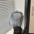 Blue denim crossbody bag with brown leather handle and vintage metal frame clasp - Light Blue