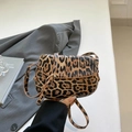 Leopard print mini saddle bag with slim strap and gold buckle in a modern urban style - Leopard Brown