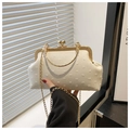 Detail of vintage cream textured dinner bag with pearl clasp and gold metal handle - White