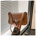 Close-up of a vintage brown bag featuring a silver heart lock and studded shoulder strap - Brown