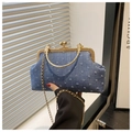 Detailed macro view of denim fabric texture with golden metal clasp and chain strap - Blue