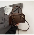 Detail of dark brown Boston bag with smooth faux leather texture and a tennis charm - With Pendant / Brown