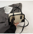 Detail of vintage beige bowler bag with black trim and elegant silk scarf accessory - With Pendant / White and Black