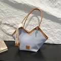 Blue denim tote bag with brown leather trim and unique V-shaped opening design - Blue
