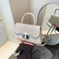 Elegant beige crossbody bag featuring woven texture flap and metallic ring buckle detail - Khaki
