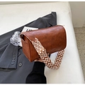 Brown leather cylinder pillow bag with geometric wide strap for casual fashion look - Brown