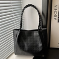 Black tote bag featuring houndstooth embossing and a stylish woven handle detail - Black