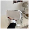 Detailed view of white crossbody bag with dual zippers and wide fabric shoulder strap - White