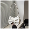 Detail of elegant white shoulder bag featuring a large decorative bow and zipper - White