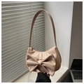 Detail of apricot shoulder bag featuring a large decorative bow and silver zipper - Khaki