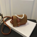 Mini brown woven crossbody bag with elegant pearl handle and leather strap detail - Brown