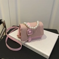 Pink mini crossbody bag featuring a pearl handle and textured woven flap detail - Pink
