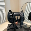 Black vintage shoulder bag in pleated leather with a large gold bow metal fastener - Black