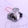 Detailed macro view of an electric DIY music box movement with battery motor and wires - Silver