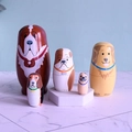 Detail of five handcrafted wooden nesting dolls with hand-painted various dog breeds - Dog Brown