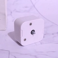 Mechanical music box movement with white plastic case and central threaded metal spindle - Silver