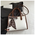 Detail of color-block tote bag with textured animal pattern and silk scarf handle - Coffee
