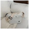 Detailed view of white pleated crossbody bag featuring adjustable fabric strap and logo badge - White