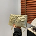 Champagne gold leather tote bag with a large bow detail and chain shoulder strap - Gold