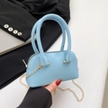 Light blue shell bag with litchi texture featuring a gold chain strap and top handles - Blue