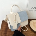 Minimalist crossbody bag with blue pleated texture and cream leather on wooden desk - Blue