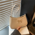 Chic beige crocodile-textured baguette bag featuring a gold metal bow ornament - Khaki