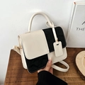 Minimalist black and white contrast leather handbag with adjustable strap and top handle - Black