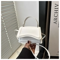 Detail of white PU leather mini handbag with unique wavy flap design and top handle - White