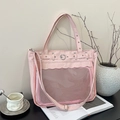 Pink minimalist transparent tote bag with heart buckle and silver studs in top view - Pink