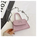 Detailed close-up of pink glitter woven bag featuring silver butterfly metal buckle - Pink