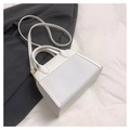 Close-up of white woven PU leather handbag detail with Fashion & Bags embossing - White