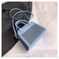 Detail of light blue handbag featuring herringbone texture panel and embossed logo - Blue