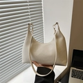Minimalist beige woven hobo bag with a half-moon design and slim shoulder strap - White